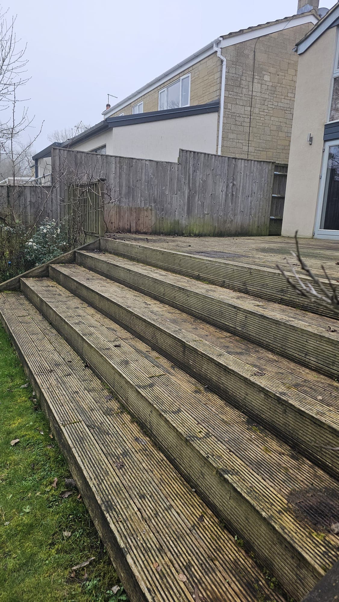 Before: old rotten wooden decking with weathered steps, ready for replacement